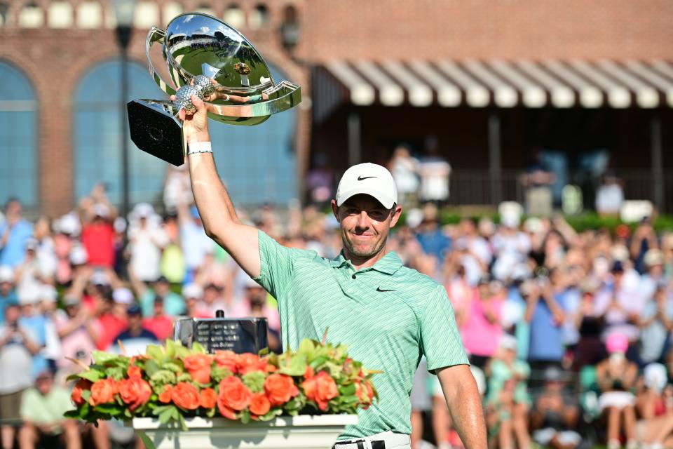 Aug 28, 2022; Atlanta, Georgia, USA; Rory McIlroy holds up the trophy on the 18th green after winning the TOUR Championship golf tournament. Mandatory Credit: Adam Hagy-USA TODAY Sports