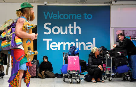 Passengers wait in the South Terminal building at Gatwick Airport, after the airport reopened to flights following its forced closure because of drone activity, in Gatwick, Britain, December 21, 2018. REUTERS/Toby Melville