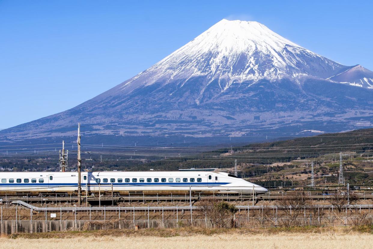 Japan - February 2, 2019: High Speed Bullet Train with Fuji Mountain Background in Winter, Shizuoka, Japan