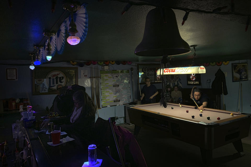 In this Feb. 23, 2019, photo, people play pool while some sit at the bar with their drinks at Soap and Suds, a popular nighttime spot, on Front Street in Nome, Alaska. (AP Photo/Wong Maye-E)
