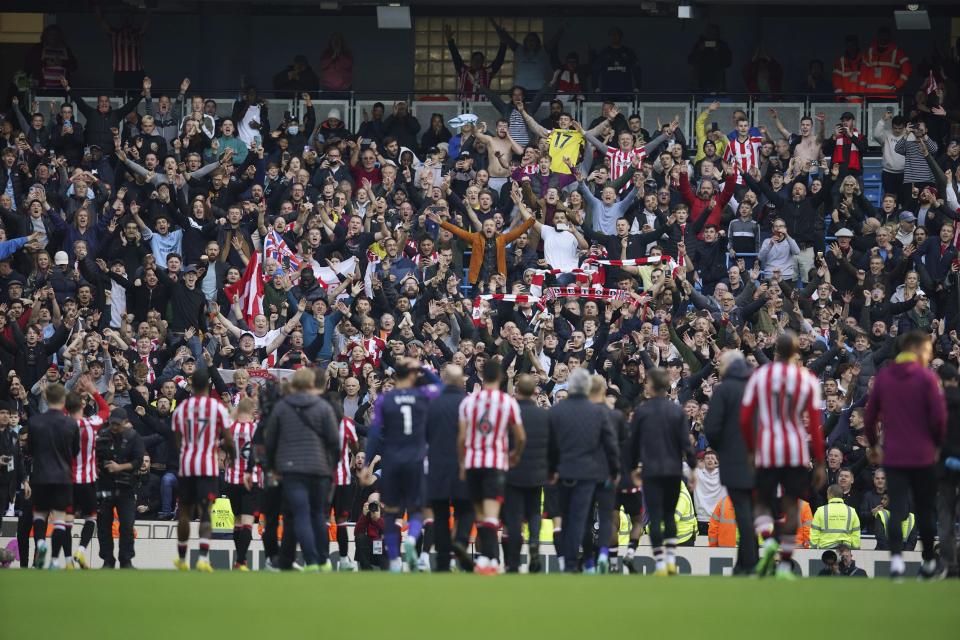Brentford players celebrate at the end of the English Premier League soccer match between Manchester City and Brentford, at the Etihad stadium in Manchester, England, Saturday, Nov.12, 2022. Brentford won 2-1. (AP Photo/Dave Thompson)