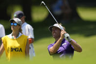 Jesse Mueller hits from the fairway on the 17th hole as his caddie and wife Jessie look on during the first round of the PGA Championship golf tournament at Southern Hills Country Club, Thursday, May 19, 2022, in Tulsa, Okla. (AP Photo/Eric Gay)