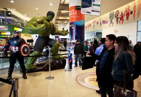 FILE PHOTO: Fans watch Avengers figures before an early premiere of "The Avengers: Endgame" movie in La Paz