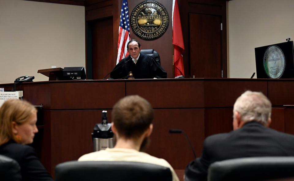 Criminal Court Judge Dee David Gay talks to Michael Cummins, bottom center, about the sentencing at the Sumner County Justice Center on Wednesday, August 16, 2023, in Gallatin Tenn. Cummins was sentenced to life in prison without the possibility of parole in the mass killings of eight people in Westmoreland in 2019. 