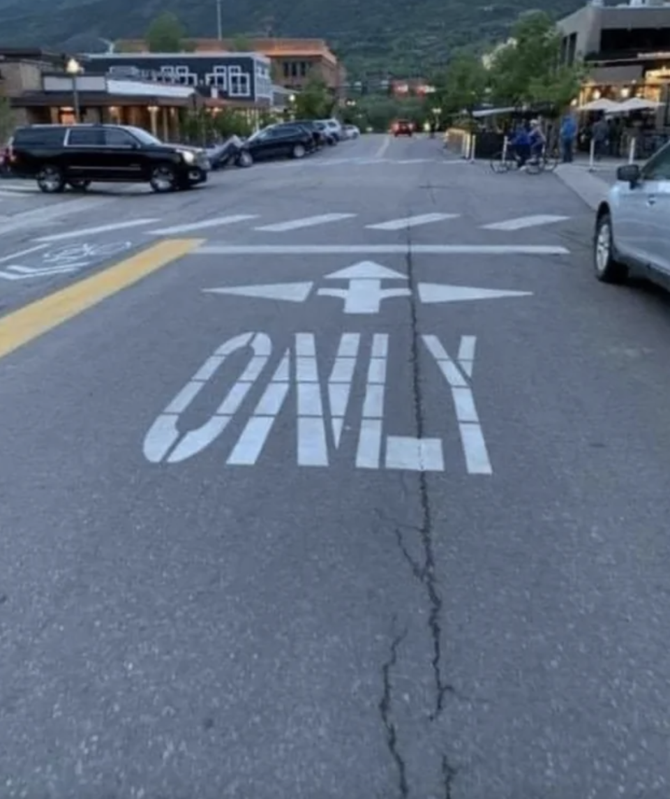 painted arrows on the street going in every direction but it says "only"