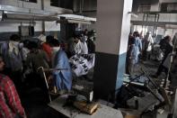 Pakistani rescue workers remove the dead body of a worker from a garment factory following a deadly fire in Karachi