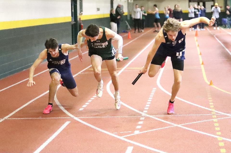 Kelton Poirier of Essex (left), Andrew Thornton-Sherman of St Johnsbury (center) and Burlington's Desmond Snyder cross the finish line together in the 4x400 relay final at the D1 Indoor Track & Field State Championship on Saturday afternoon at the University of Vermont.