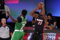 Boston Celtics guard Jaylen Brown (7) defends as Miami Heat forward Jimmy Butler (22) goes up for a shot during the second half of Game 4 of an NBA basketball Eastern Conference final, Wednesday, Sept. 23, 2020, in Lake Buena Vista, Fla. (AP Photo/Mark J. Terrill)