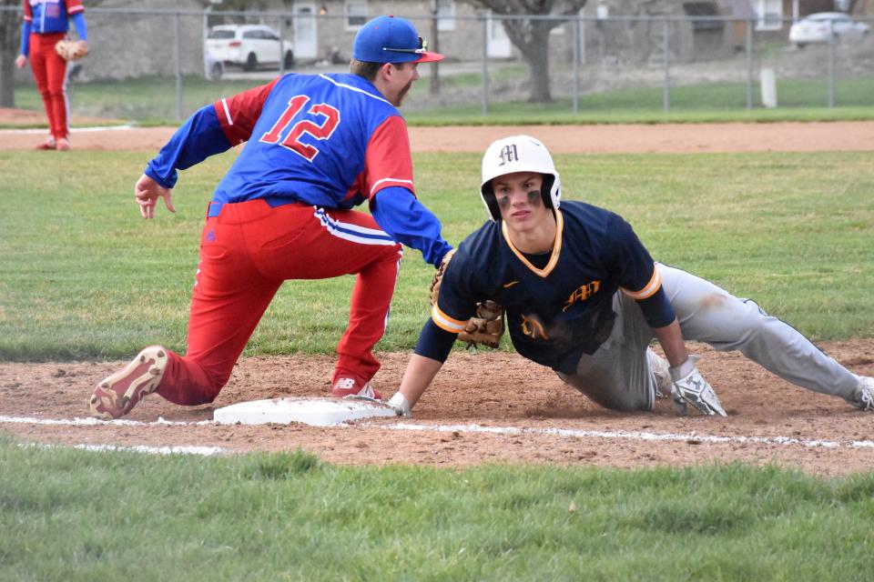 Mooresville's Logan Jackson is called safe at first base after Martinsville's Matt Decker tries to tag him out during their rivalry matchup on April 7, 2022.