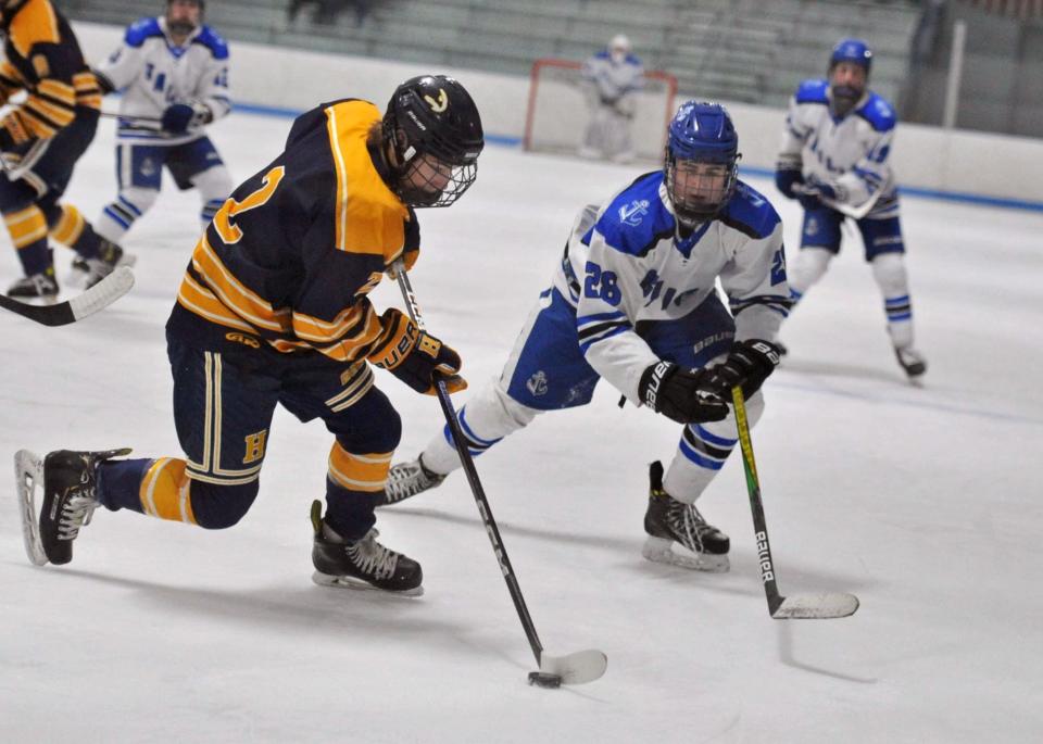 Scituate's Theodore Hare, right, puts the pressure on Hanover's Aiden Richards, left, during boys high school hockey action at the Hobomock Arena in Pembroke, Wednesday, Feb. 7, 2024.