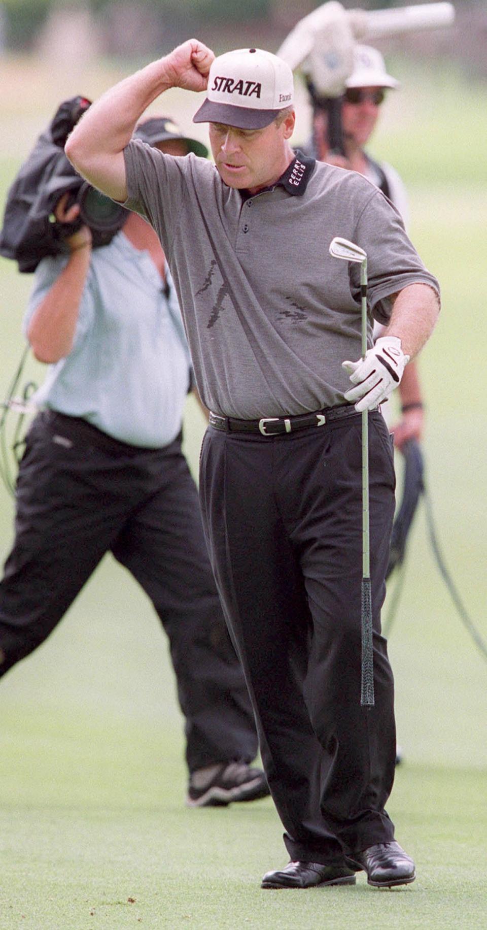 Hal Sutton gives a fist pump after hitting his 6-iron into the 18th green at the Stadium Course to insure his 2000 Players title.