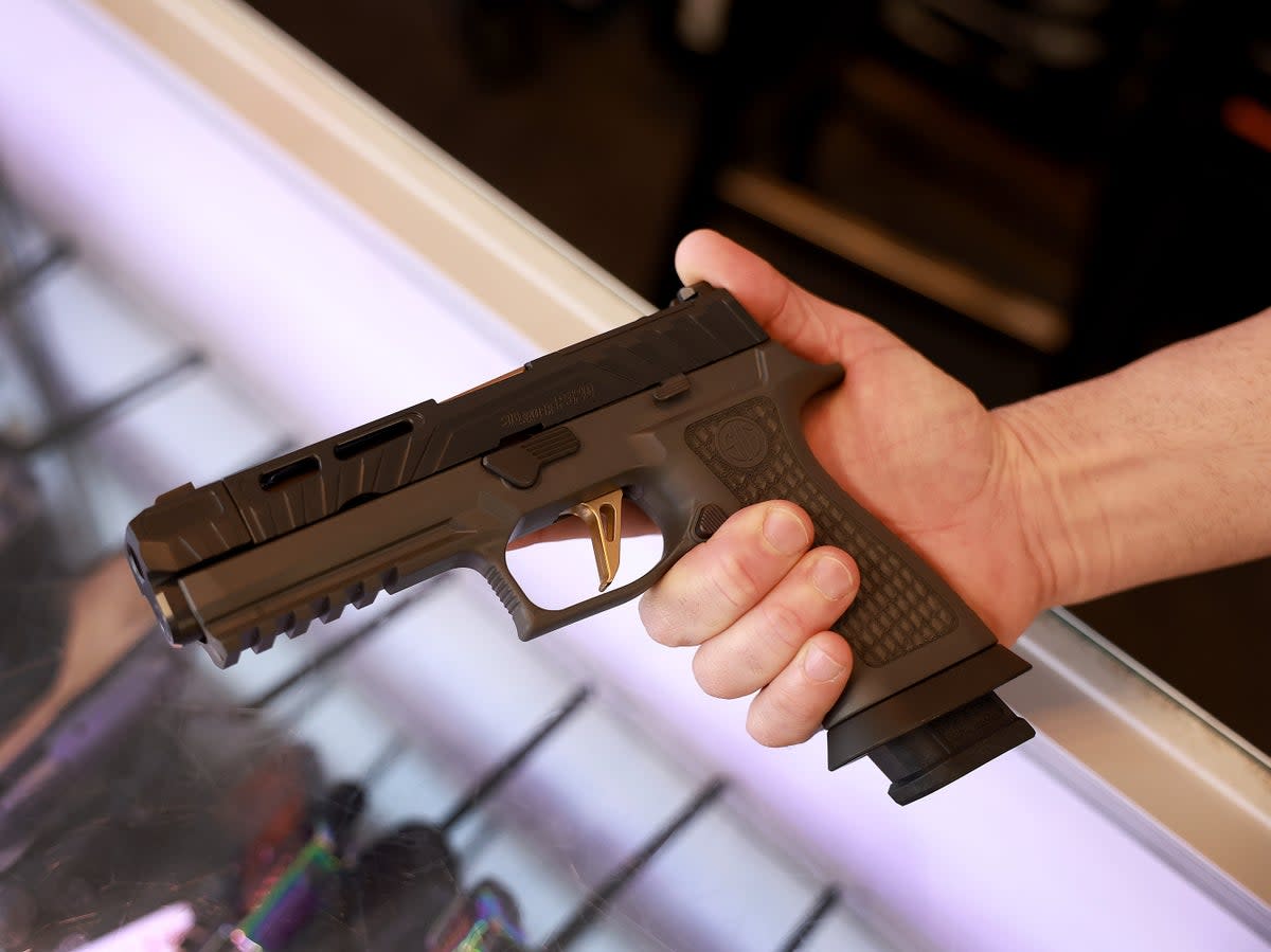 A Sig Sauer P320 handgun is held at the WEX Gunworks store in Delray Beach, Florida (Joe Raedle/Getty)