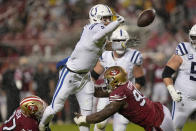 Indianapolis Colts quarterback Carson Wentz, top, throws an interception while pressured by San Francisco 49ers defensive end Nick Bosa, bottom left, and defensive end Kentavius Street during the first half of an NFL football game in Santa Clara, Calif., Sunday, Oct. 24, 2021. (AP Photo/Tony Avelar)