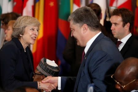 Ukraine's President Petro Poroshenko (R) greets British Prime Minister Theresa May as he arrives for a luncheon during the United Nations General Assembly at United Nations headquarters in New York City, U.S. September 20, 2016. REUTERS/Lucas Jackson