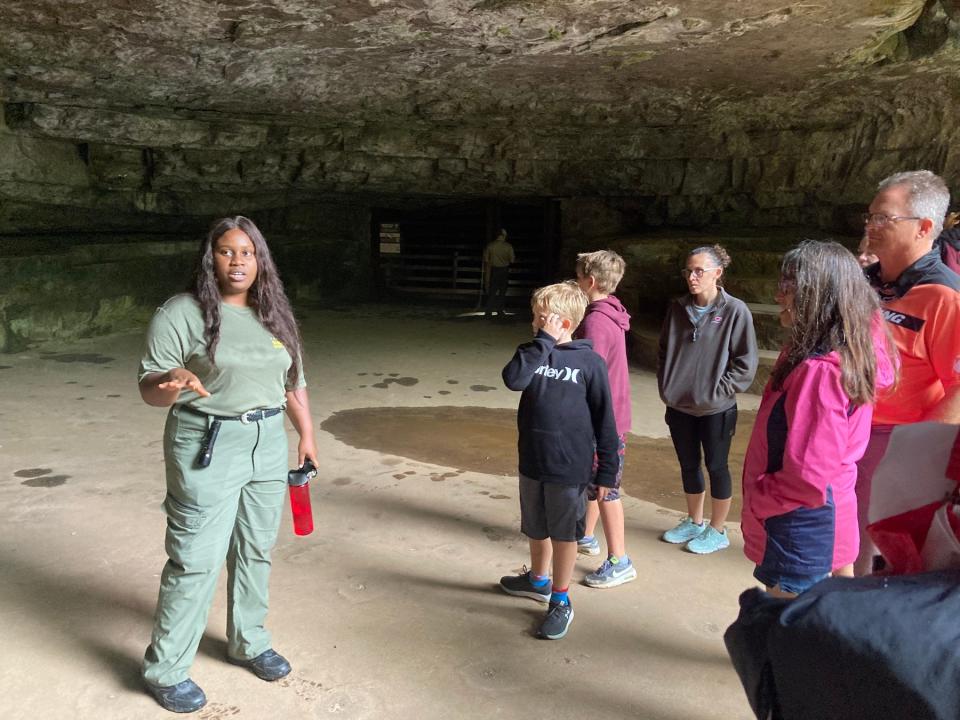 APSU graduate history student Ifunanya Ejimofor leads a guided tour group through Dunbar Cave as part of her summer internship.