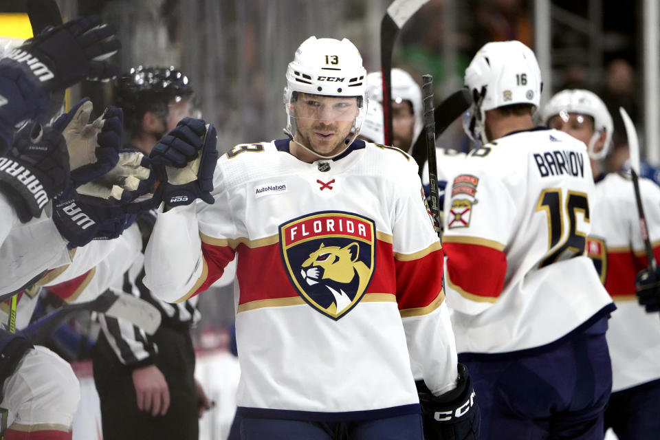 Florida Panthers center Sam Reinhart (13) is congratulated as he passes the team box after scoring against the Colorado Avalanche in the first period of an NHL hockey game Saturday, Jan. 6, 2024, in Denver. (AP Photo/David Zalubowski)
