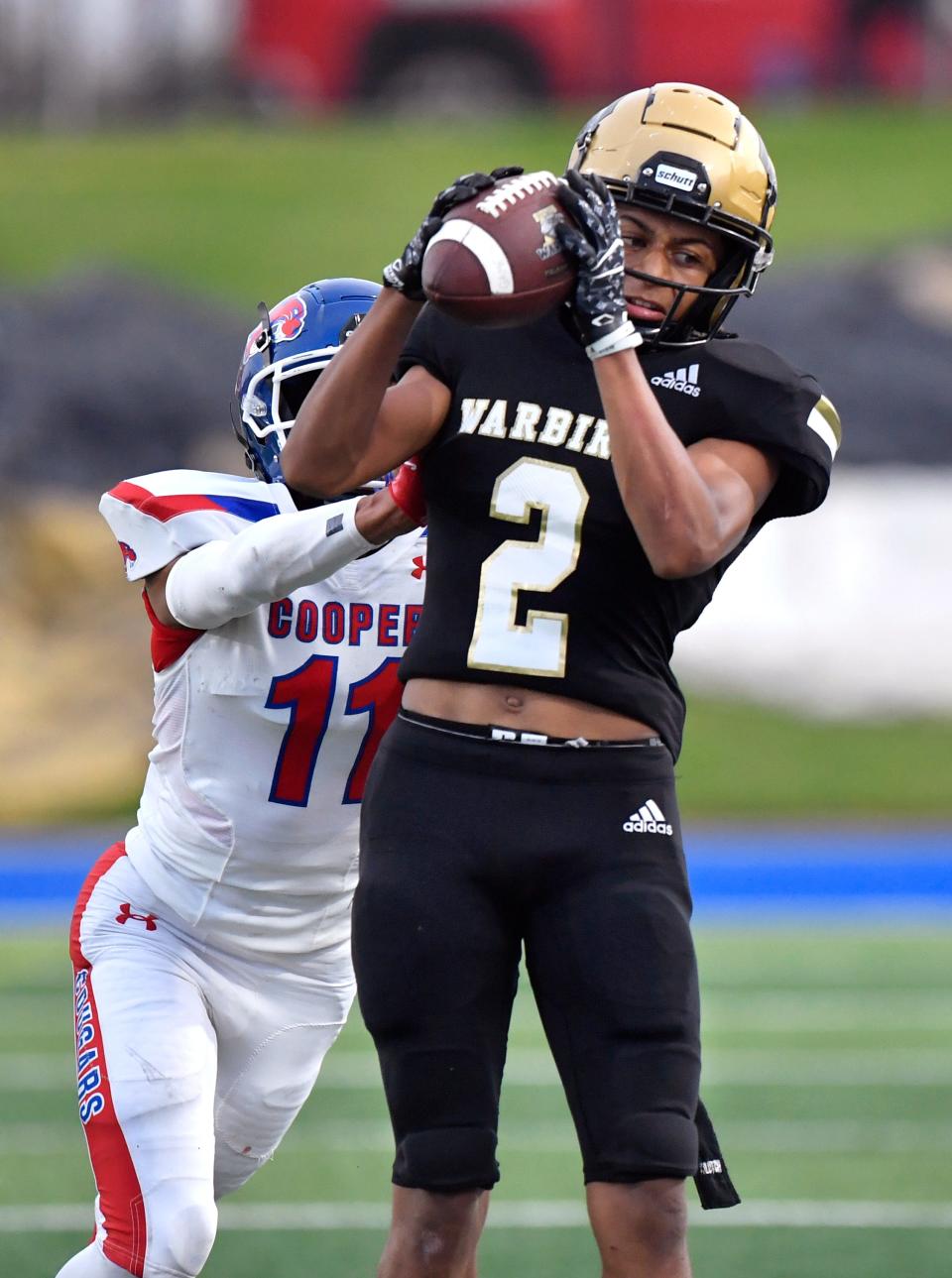 Abilene High's Jayson Henley catches a pass as Cooper defensive back Michael Ramis pushes him out of bounds during Friday's Crosstown Showdown at Shotwell Stadium.