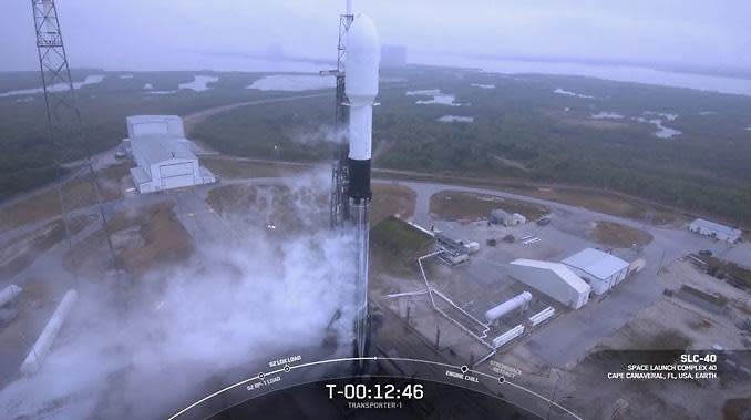 Bad weather across Cape Canaveral forced SpaceX to order a 24-hour delay for the launch of a record 143 small satellites aboard a Falcon 9 rocket. The team will try again Sunday. / Credit: SpaceX webcast