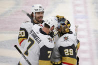 Vegas Golden Knights defenseman Alex Pietrangelo (7) congratulates goaltender Marc-Andre Fleury (29) as center Chandler Stephenson (20) smiles after the team's NHL hockey game against the Minnesota Wild, Wednesday, May 5, 2021, in St. Paul, Minn. The Golden Knights won 3-2 in overtime on Pietrangelo's goal. (AP Photo/Andy Clayton-King)