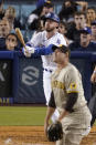 Los Angeles Dodgers' Cody Bellinger, left, hits a solo home run as San Diego Padres relief pitcher Craig Stammen watches during the sixth inning of a baseball game Friday, July 1, 2022, in Los Angeles. (AP Photo/Mark J. Terrill)