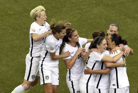 Jun 30, 2015; Montreal, Quebec, CAN; United States midfielder Carli Lloyd (10) celebrates with teammates after scoring on a penalty kick against Germany during the second half of the semifinals of the FIFA 2015 Women's World Cup at Olympic Stadium. Mandatory Credit: Eric Bolte-USA TODAY Sports -