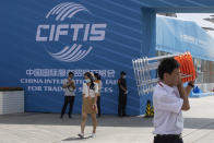 A man carries a stack of chairs near a venue for the China International Fair for Trade in Services (CIFTIS) in Beijing on Friday, Sept. 4, 2020. As China recovers from the COVID-19 pandemic, business as usual is picking back up with the holding of the China International Fair for Trade in Services. Nearly 2,000 Chinese and foreign enterprises will participate and showcase their newest technology in public health and digital technology (AP Photo/Ng Han Guan)