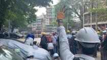 Video grab of protesters standing behind a barricade in Sanchaung, Yangon, Myanmar