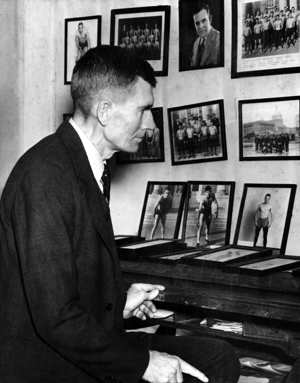     Photo of Oklahoma A&M athletic director Ed Gallagher  amidst photos of his athletes taken in February of 1939.  Photo probably taken in Gallagher's Stillwater, OK, office.  Gallagher died some 18 months later on 8/28/1940.Staff photo by A. Y. Owen taken 2/3/1939; photo ran in the 8/28/1940 Oklahoma City Times.