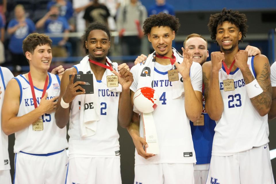 Jul 16, 2023; Toronto, Ontario, Canada; USA-Kentucky guard Reed Sheppard (15) and guard Antonio Reeves (12) and forward Tre Mitchell (4) and guard Jordan Burks (23) pose with their tournament medals and trophy after defeating Canada in the Men's Gold game at Mattamy Athletic Centre. Mandatory Credit: John E. Sokolowski-USA TODAY Sports