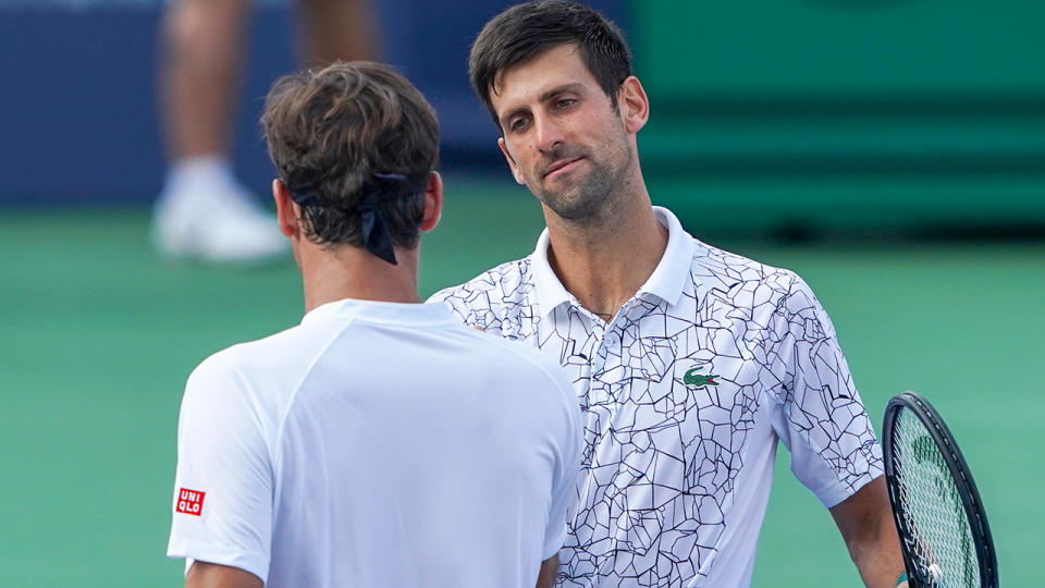 Novak Djokovic shakes hands with Roger Federer. (Photo by Adam Lacy/Icon Sportswire via Getty Images)