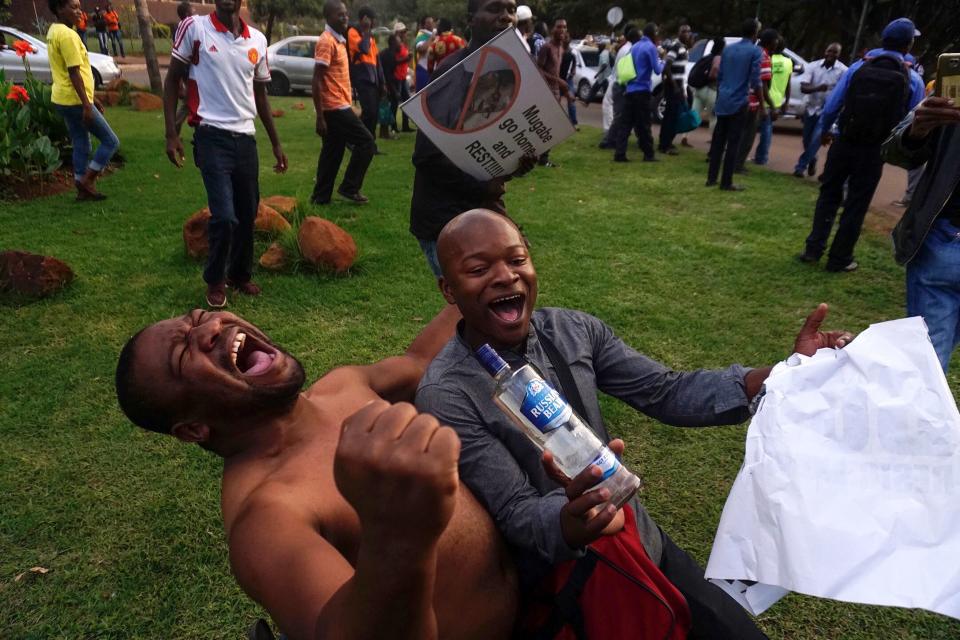 Men celebrate Mugabe's resignation.