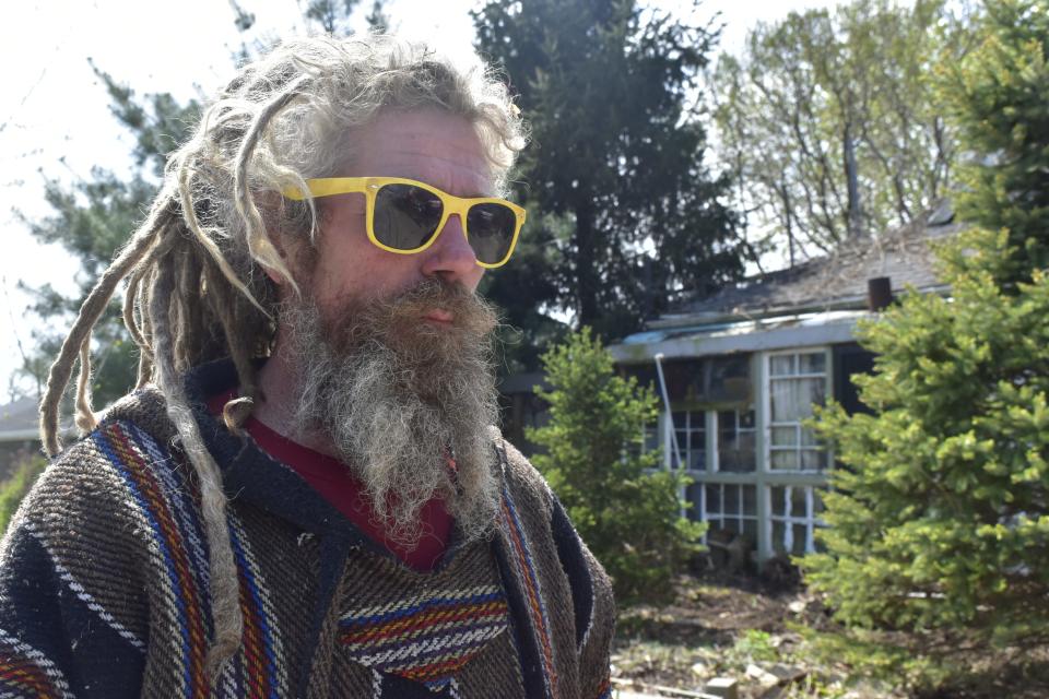 Robert Lowers stands in front of his home on Main Street in Ellettsville on April 26, 2023.