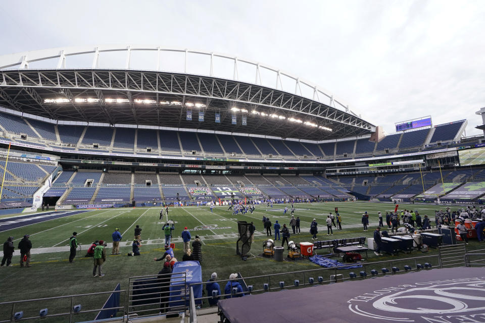 The Seattle Seahawks play against the Los Angeles Rams in an otherwise empty stadium during the first half of an NFL wild-card playoff football game, Saturday, Jan. 9, 2021, in Seattle. (AP Photo/Ted S. Warren)