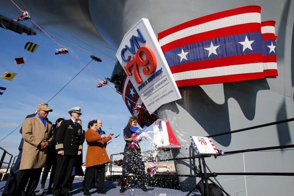 Caroline Kennedy smashes a bottle of sparkling wine on the new John F. Kennedy ship during a ceremony Saturday.