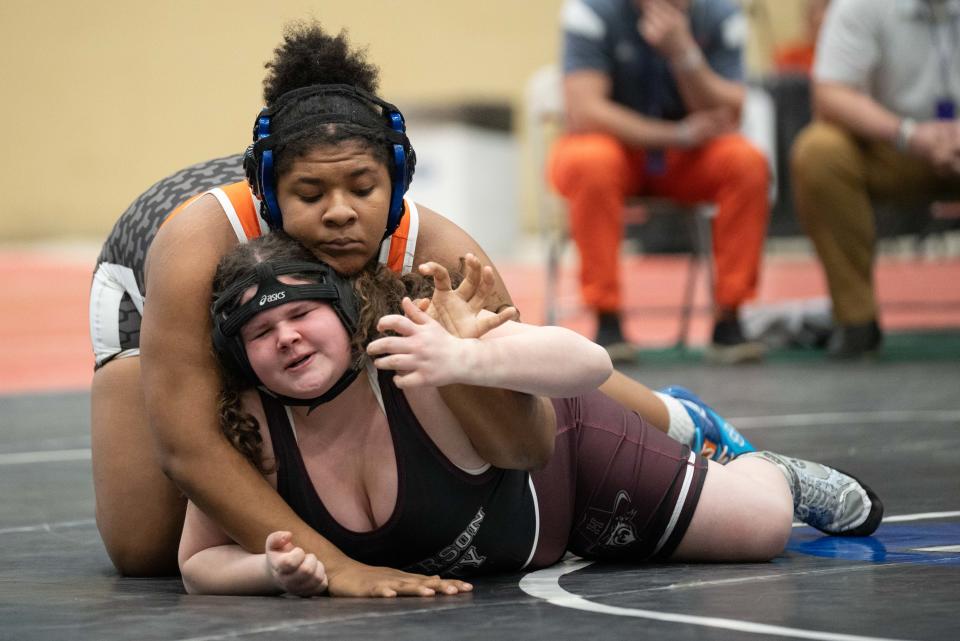 Fern Creek’s Gabby Wilson takes down Henderson County’s Evelyn Estes in a state semifinal wrestling match Saturday in Lexington.