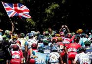 Cycling - Tour de France cycling race - The 184-km (114,5 miles) Stage 8 from Pau to Bagneres-de-Luchon, France - 09/07/2016 - A supporter holds a British flag as the pack of riders cycles during the stage. REUTERS/Juan Medina