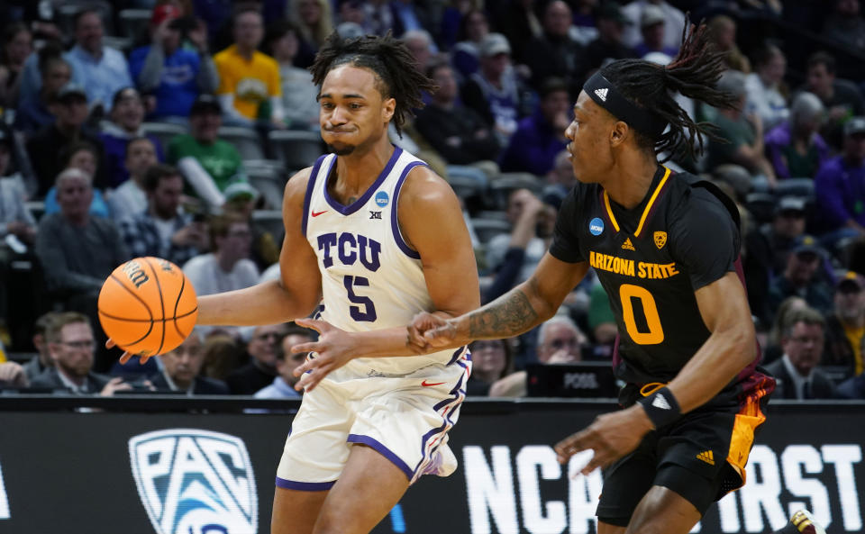 TCU forward Chuck O'Bannon Jr., left, drives to the basket past Arizona State guard DJ Horne in the first half of a first-round college basketball game in the men's NCAA Tournament, Friday, March 17, 2023, in Denver. (AP Photo/John Leyba)