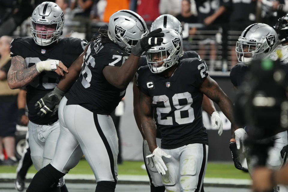 Las Vegas Raiders running back Josh Jacobs (28) celebrates after scoring a touchdown against the Baltimore Ravens during the second half of an NFL football game, Monday, Sept. 13, 2021, in Las Vegas. (AP Photo/Rick Scuteri)