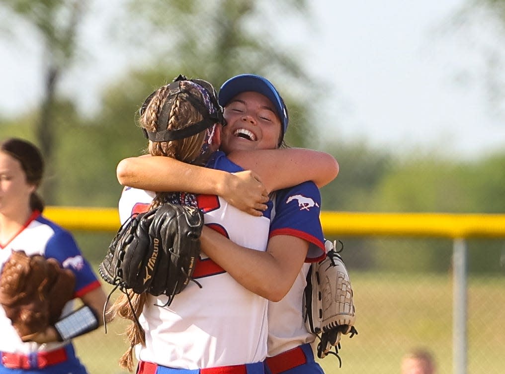 Tuslaw seniors Macaira Fox (right) and Meridith Rankl (left) are all smiles as they hug after earning back-to-back District Championships in Div. III with an 11-1 win over Norwayne.