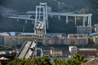 <p>Abandoned vehicles on the Morandi motorway bridge after a section collapsed in the north-western Italian city of Genoa, leaving dozens dead. (Getty) </p>