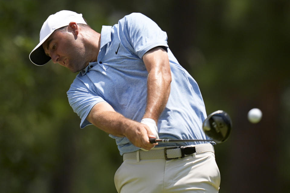 Scottie Scheffler watches his tee shot on the 11th hole during the third round of the U.S. Open golf tournament Saturday, June 15, 2024, in Pinehurst, N.C. (AP Photo/Mike Stewart)