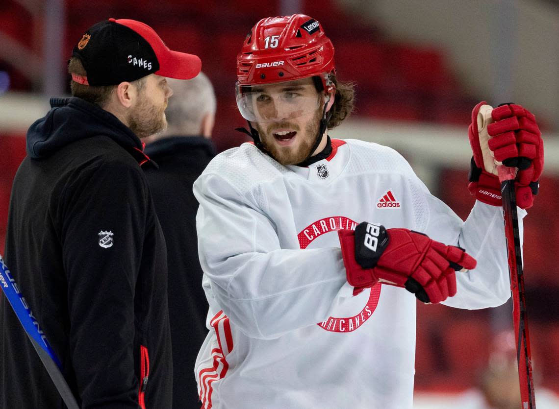 Carolina Hurricanes defenseman Dylan Coghlan (15) talks with assistant coach Tim Gleason during practice on Thursday, May 2, 2024 at PNC Arena in Raleigh, N.C. Coghlan wears a high-tech Kevlar undershirt with a collar to protect his neck from a possible skate cut. Robert Willett/rwillett@newsobserver.com