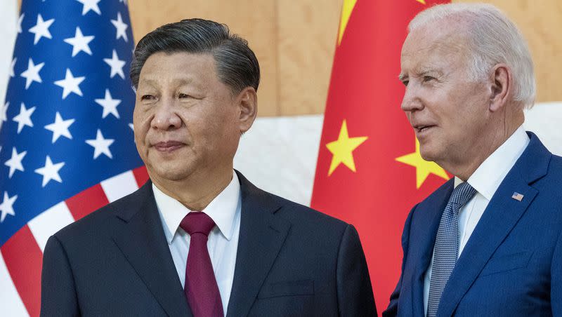 U.S. President Joe Biden, right, stands with Chinese President Xi Jinping before a meeting on the sidelines of the G20 summit meeting on Nov. 14, 2022, in Bali, Indonesia. On Tuesday, Biden described Jinping as a dictator, prompting a response from China’s foreign ministry.