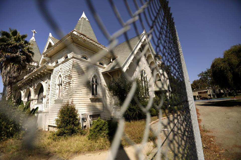 The Wadsworth Chapel behind a chain-link fence.