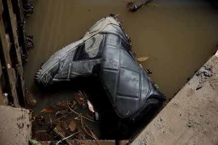 A shoe is seen floating in water after an overflowed Coyote Creek flooded nearby neighborhoods and prompted an evacuation in San Jose, California, U.S., February 22, 2017. REUTERS/Stephen Lam