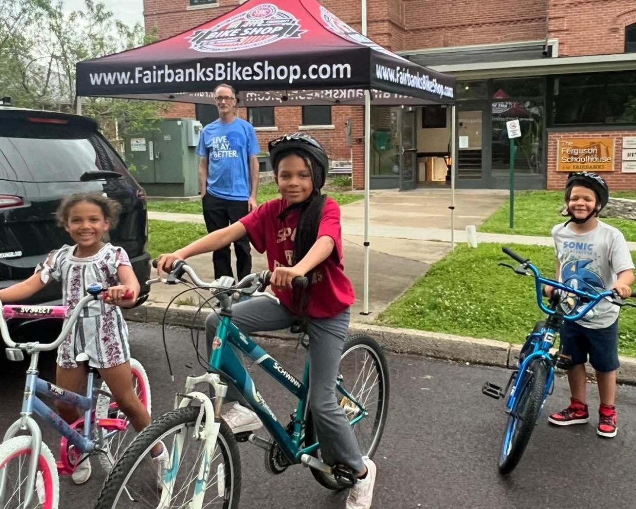 Three children smile with new bicycles they received from Springfield Brewing Company's Community Bike Shop on Wednesday, May 8, 2024. The bike shop is located at The Fairbanks Community Hub at 1126 N. Broadway Ave.