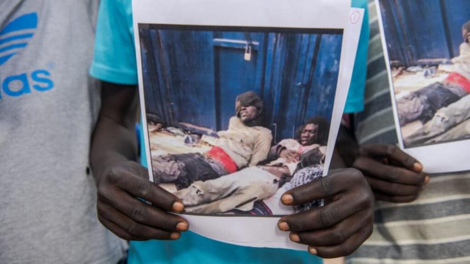 A protester holds images of the violence other immigrants suffered when they arrived at the border between Spain and Morocco. Dozens of people gathered at the Plaza de España in the city of Melilla to demand the action of the security forces of both countries in the massive entry attempt by hundreds of migrants, mainly from sub-Saharan Africa. (Photo by Israel Fuguemann/SOPA Images/LightRocket via Getty Images)