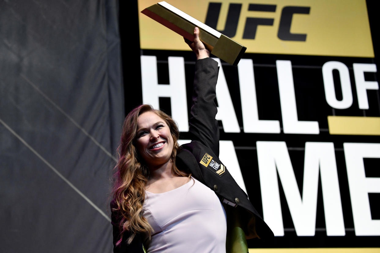 Ronda Rousey poses with her trophy after her induction into the UFC Hall of Fame.