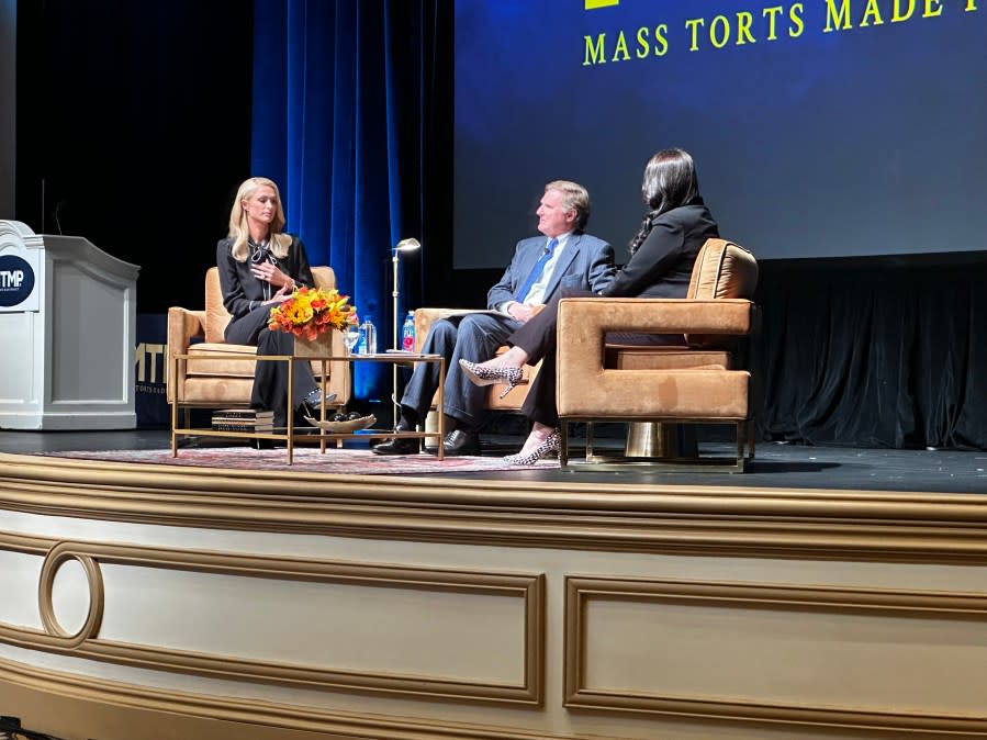 Paris Hilton (left) speaks with Attorney Mike Papantonio (middle) and Democratic Oregon State Senator Sara Gelser Blouin (right) about the ‘troubled teen’ industry during the Mass Torts Made Perfect conference at the Bellagio Hotel & Casino Wednesday morning. (KLAS)