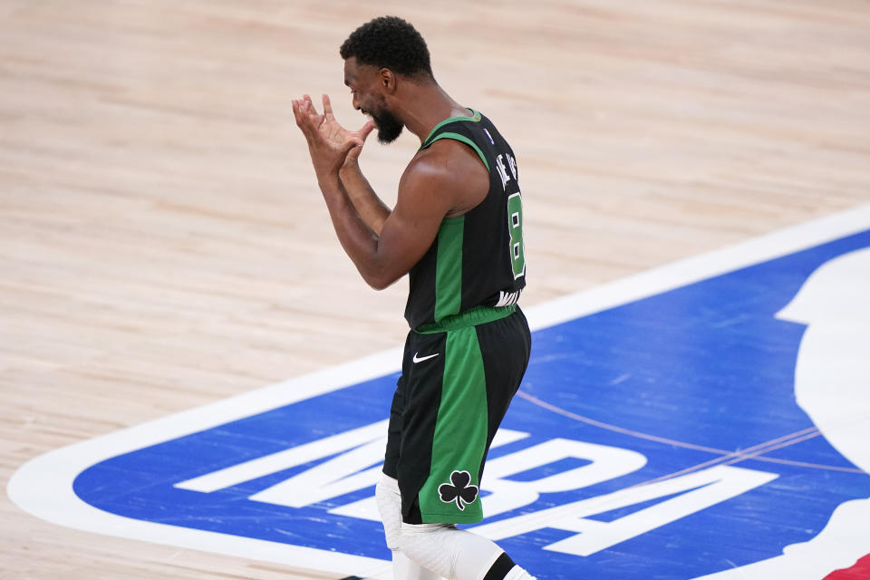 Boston Celtics' Kemba Walker (8) reacts to a play against the Miami Heat during the second half of an NBA conference final playoff basketball game Friday, Sept. 25, 2020, in Lake Buena Vista, Fla. The Celtics won 121-108. (AP Photo/Mark J. Terrill)